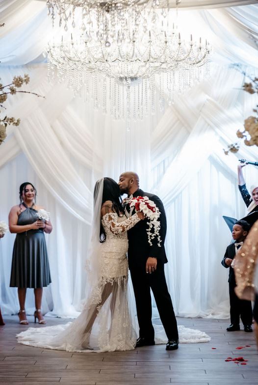 Newlywed kissing on the wedding hall | Wedding Photography | Cherished memories studio