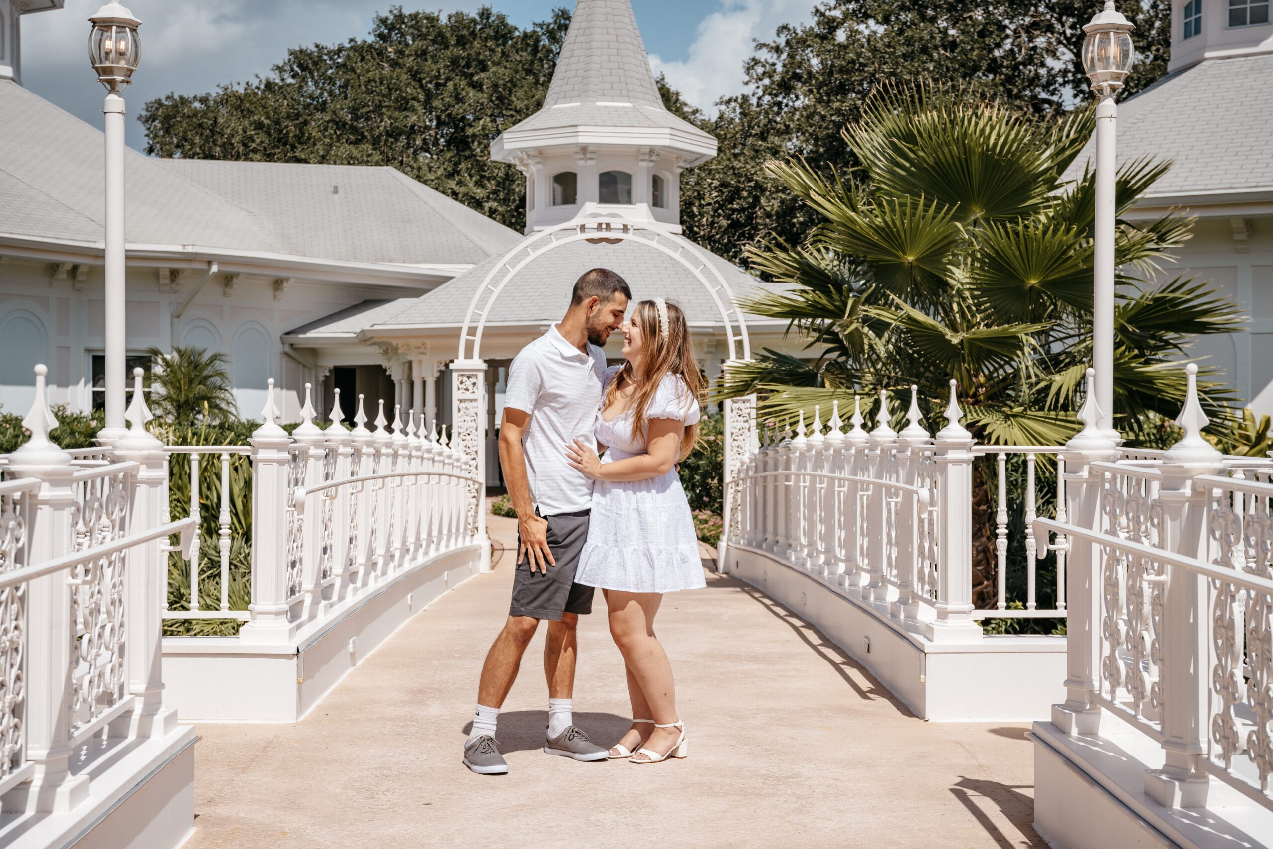 Bride and groom kissing on a wooden dock beside the water during their Florida wedding celebration.