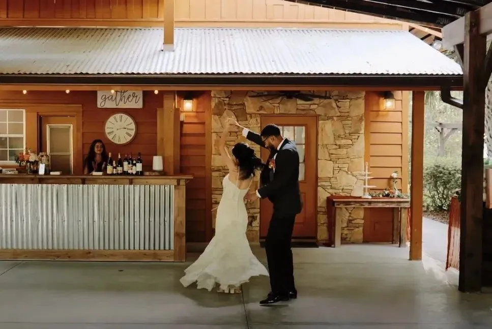 Bride and groom sharing their first dance at a rustic Florida wedding venue.