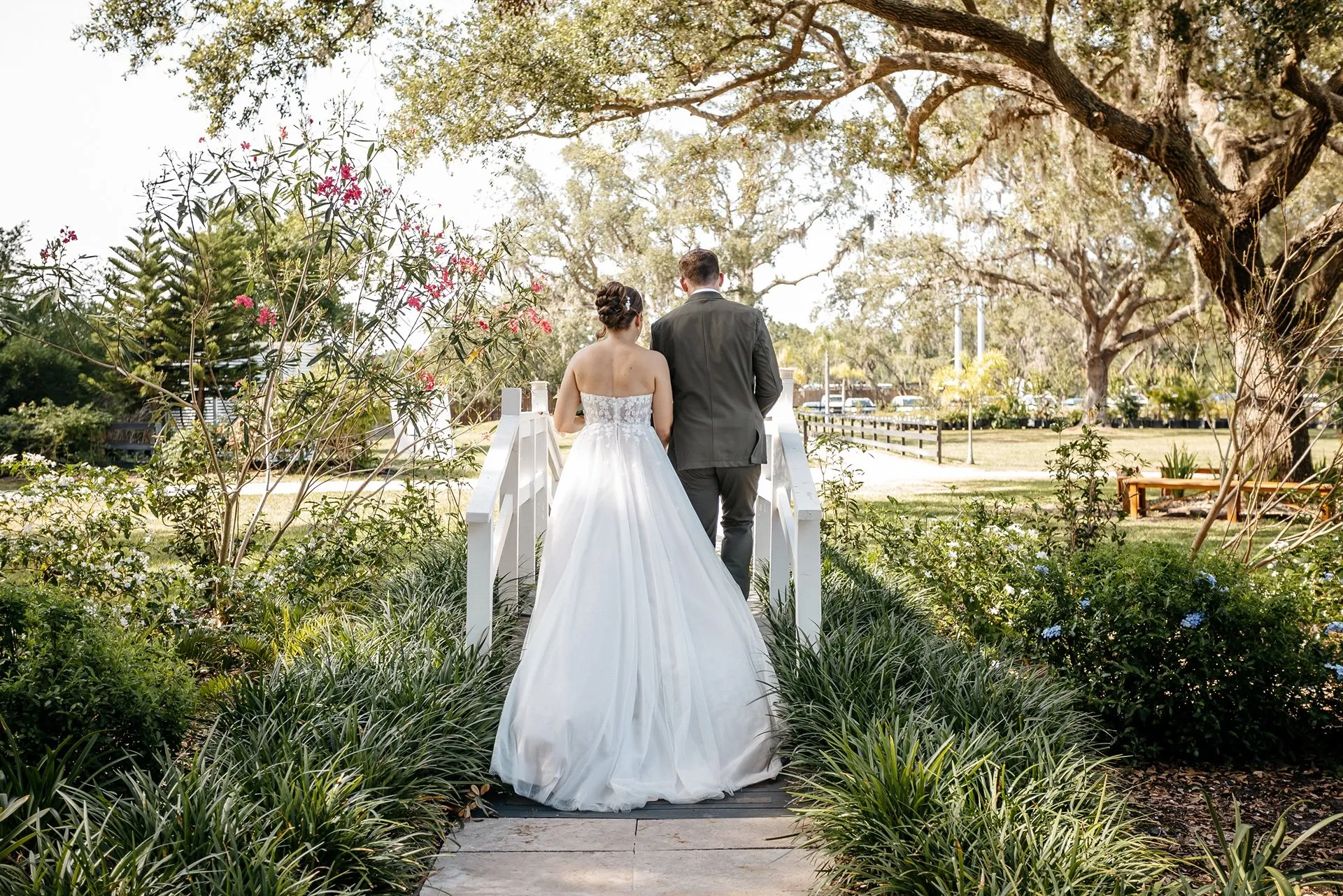 Bride and groom walk through a garden together at their micro wedding in Central Florida