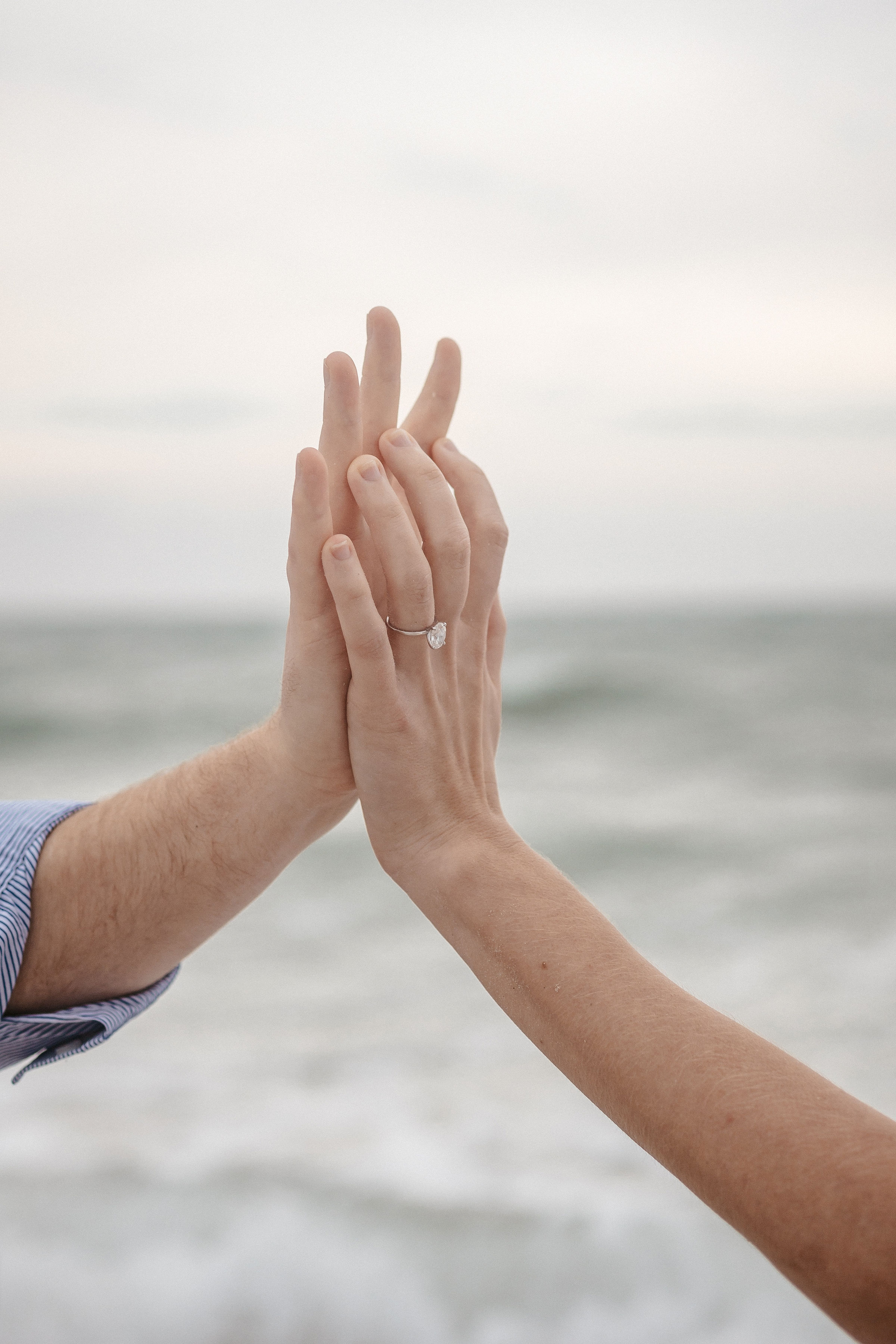 Holding hands with the sea background | Wedding Photography