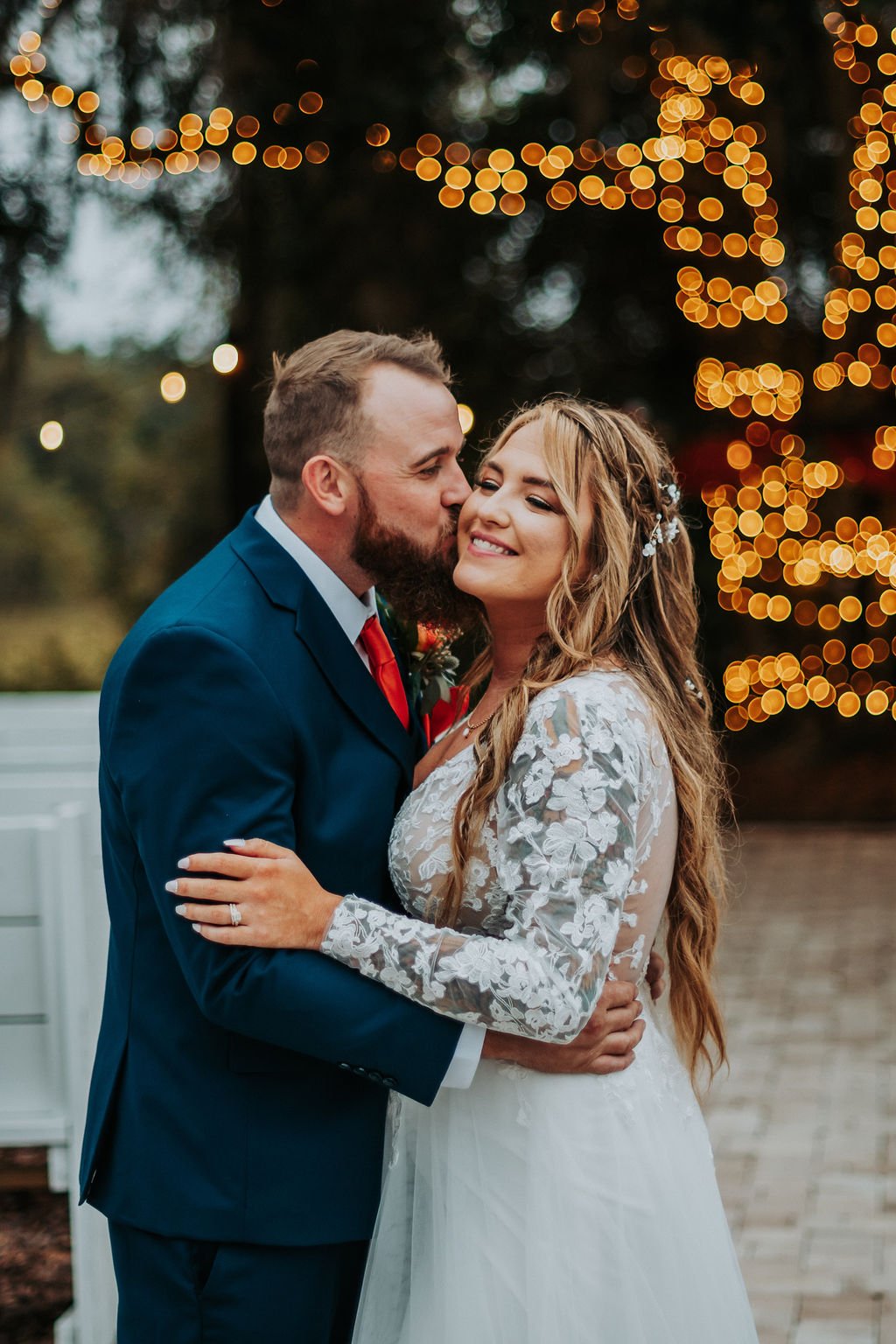 The groom kissing his bride on the cheeks | Wedding Photography