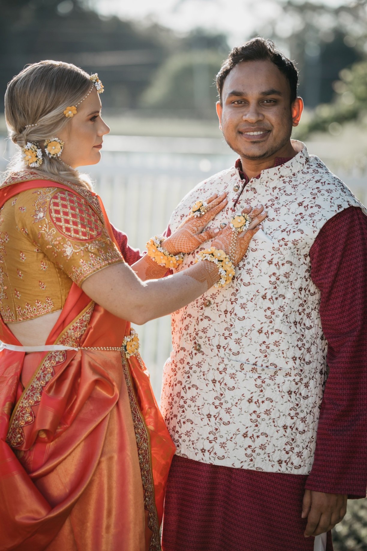 Bride and groom are dressed in traditional clothes and smile at the camera for their 520 on the water photos