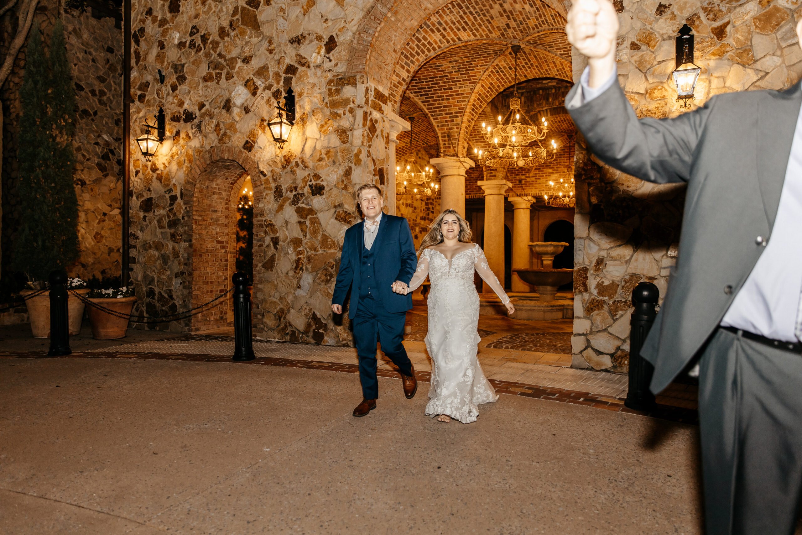 Bride and groom hold hands while leaving their Bella Collina Orlando wedding venue