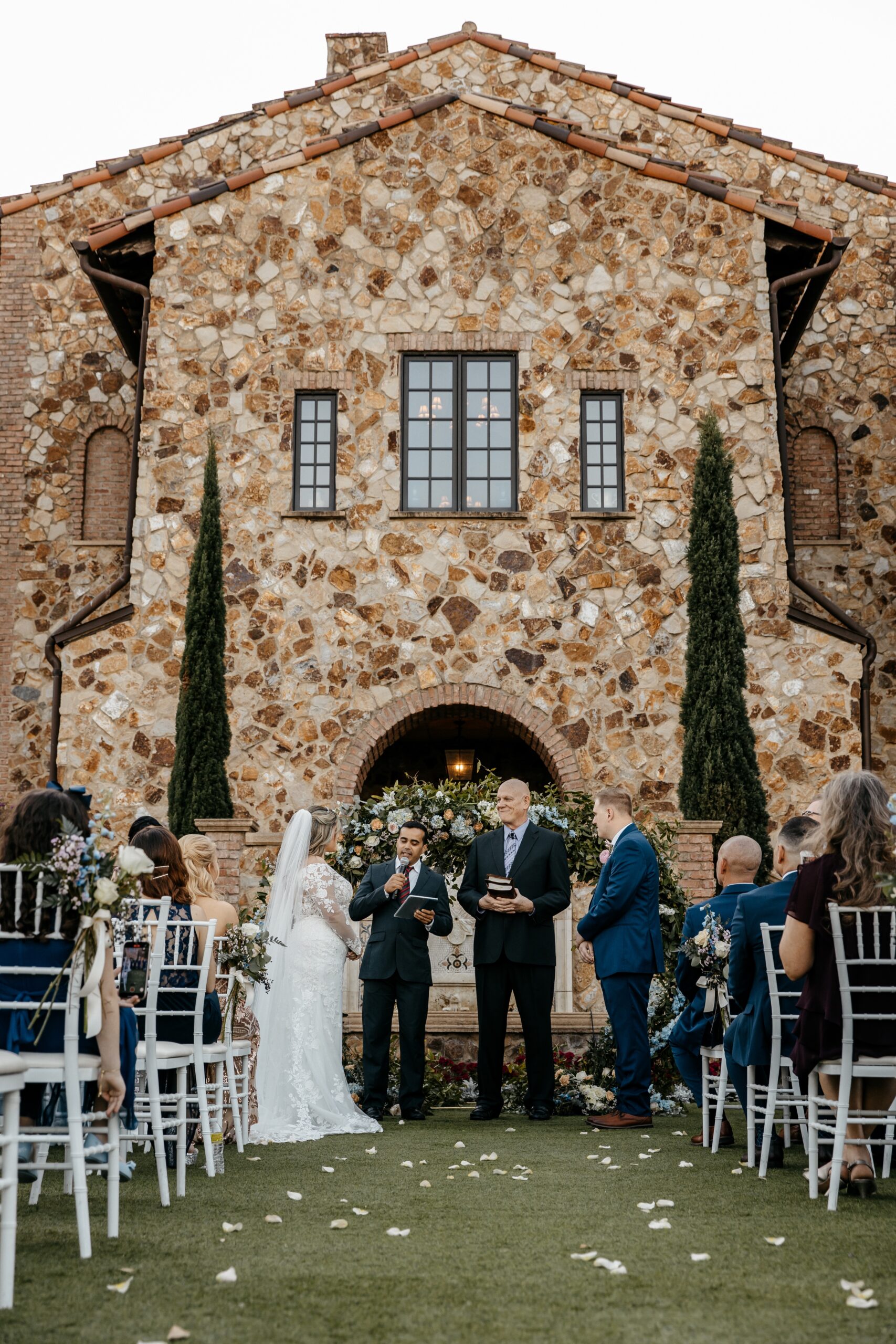 Bride and groom listen as one of the pastors speak at her and her husband's wedding at one of the best Central Florida wedding venues