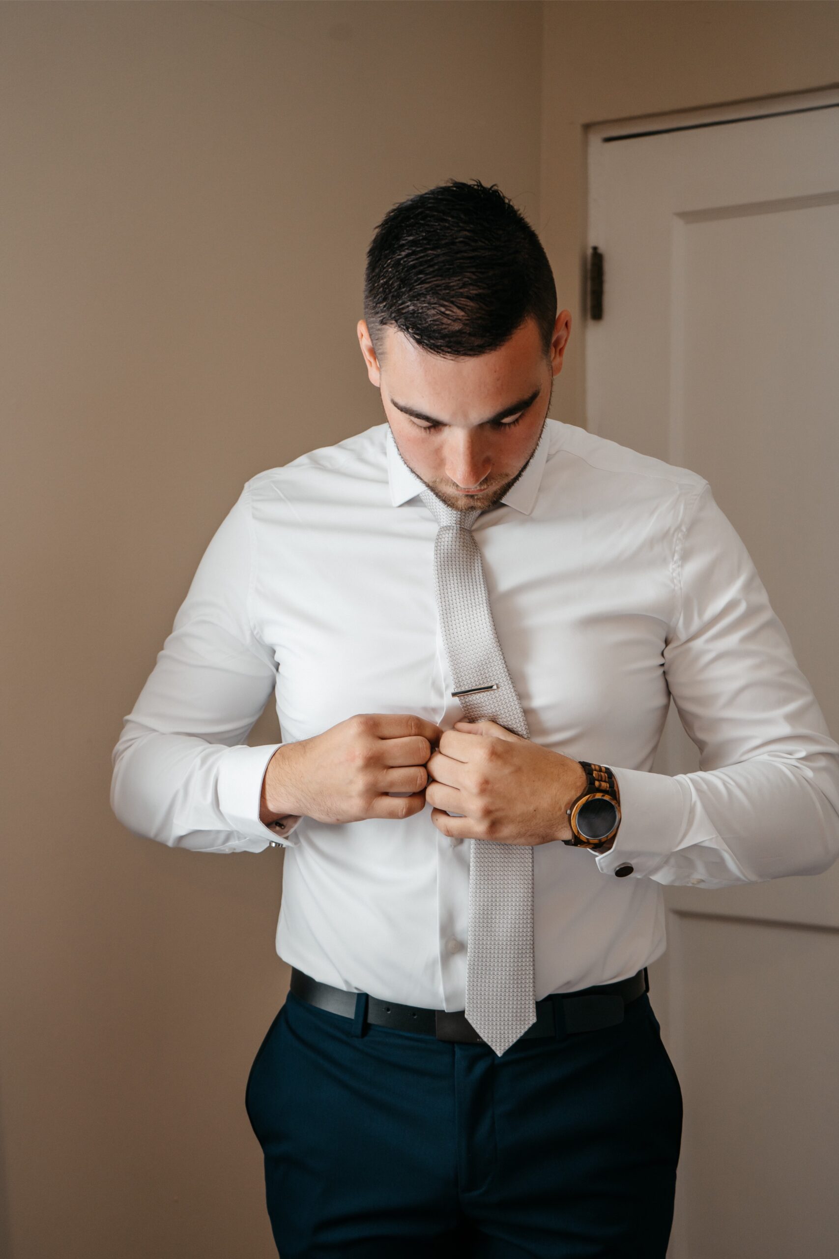 A groom is photographed getting ready for his wedding by the best wedding videographer in Central Florida