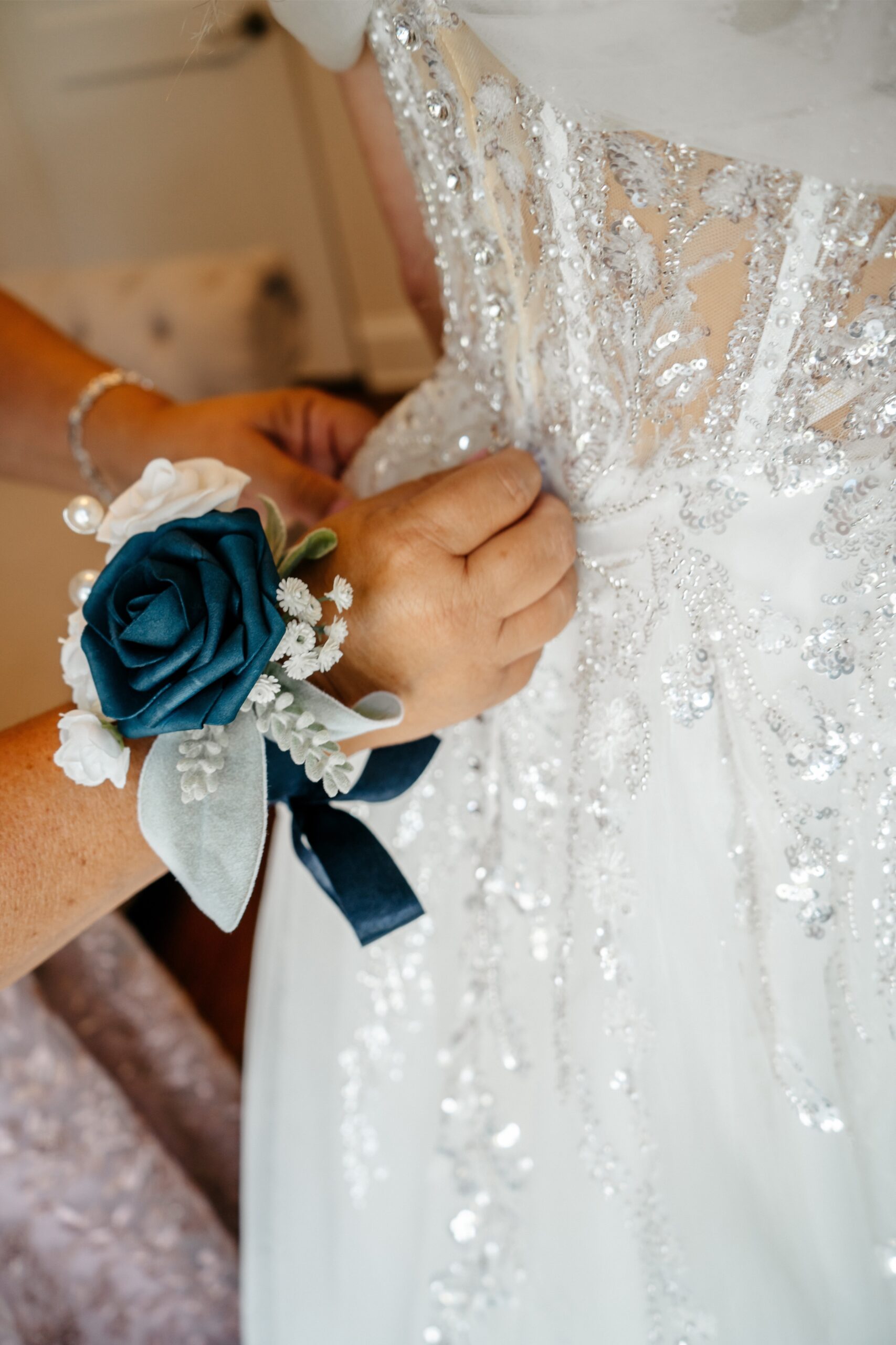 The best wedding videographer in Central Florida takes photos of the Mother of the Bride helping her daughter get ready for her wedding