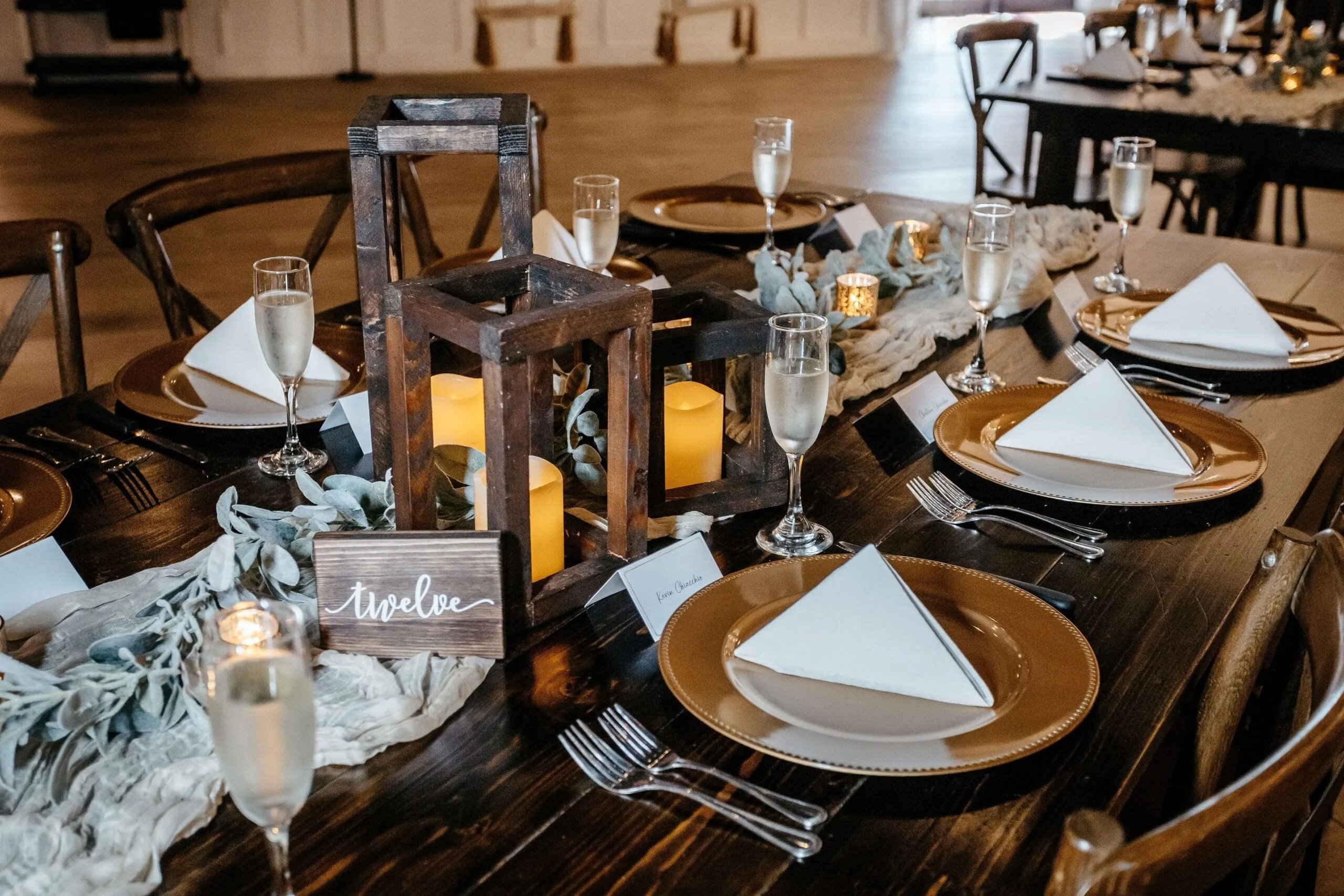 Elegant wedding reception table with candles, champagne glasses, and place settings photographed by a Florida wedding photographer.