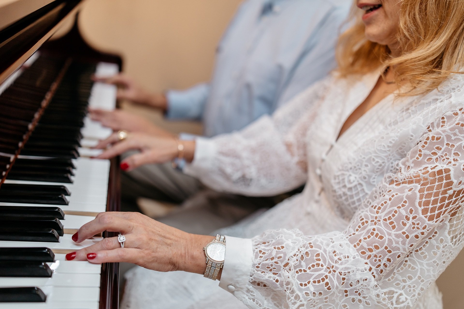 Husband and wife play a piano and sing together during their wedding in Central Florida