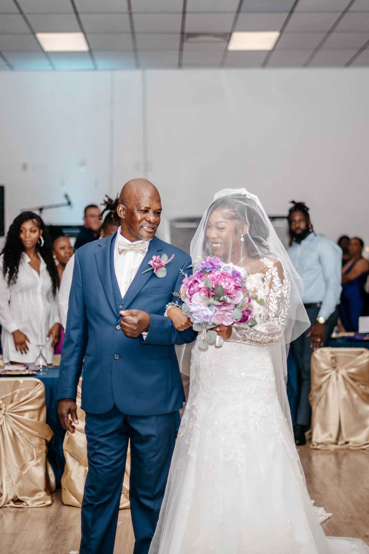 A bride is escorted down the aisle by her father in front of their friends and family at a Central Florida wedding