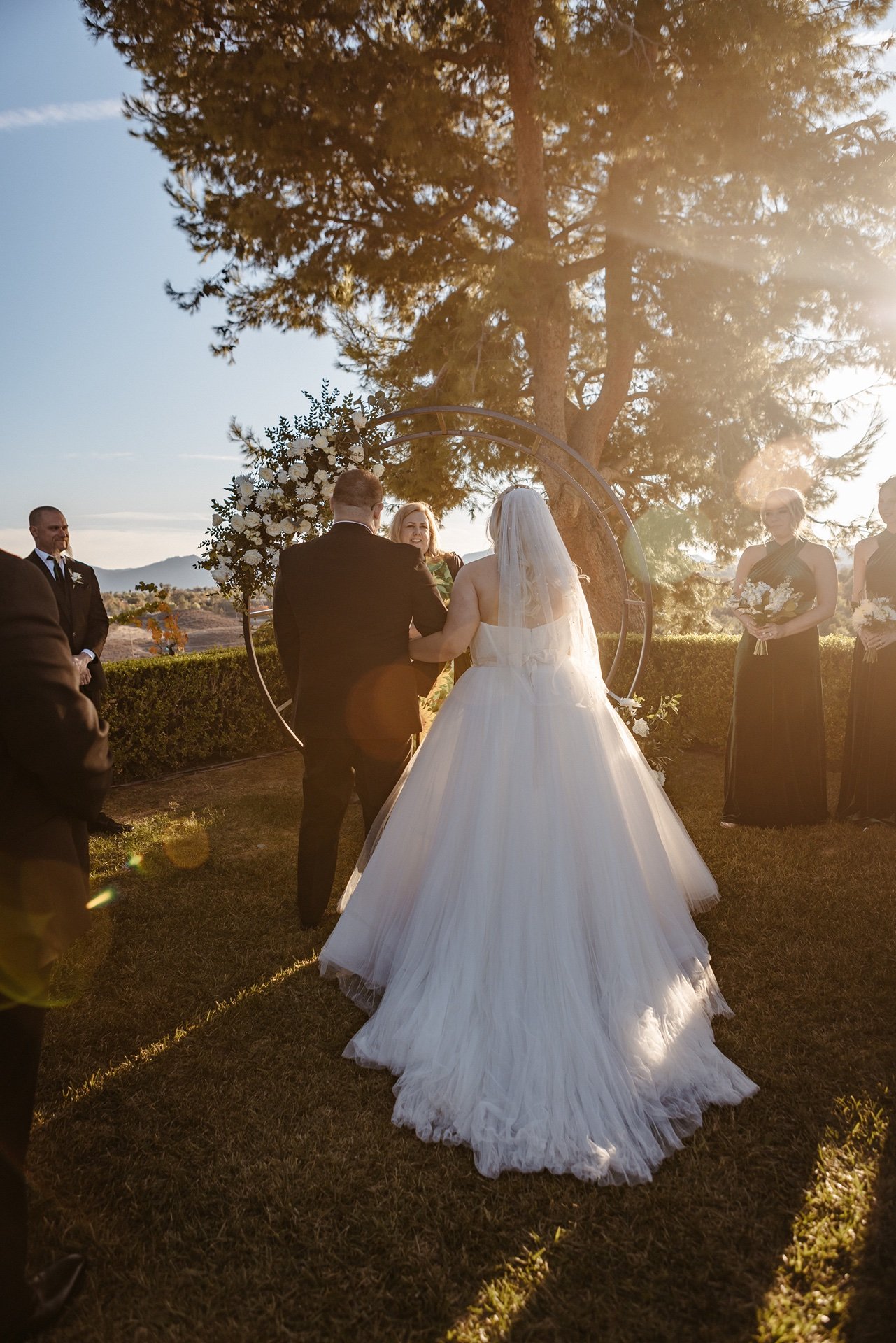 A bride and groom stand at the altar with the officiant during golden hour at a wedding venue in Central Florida