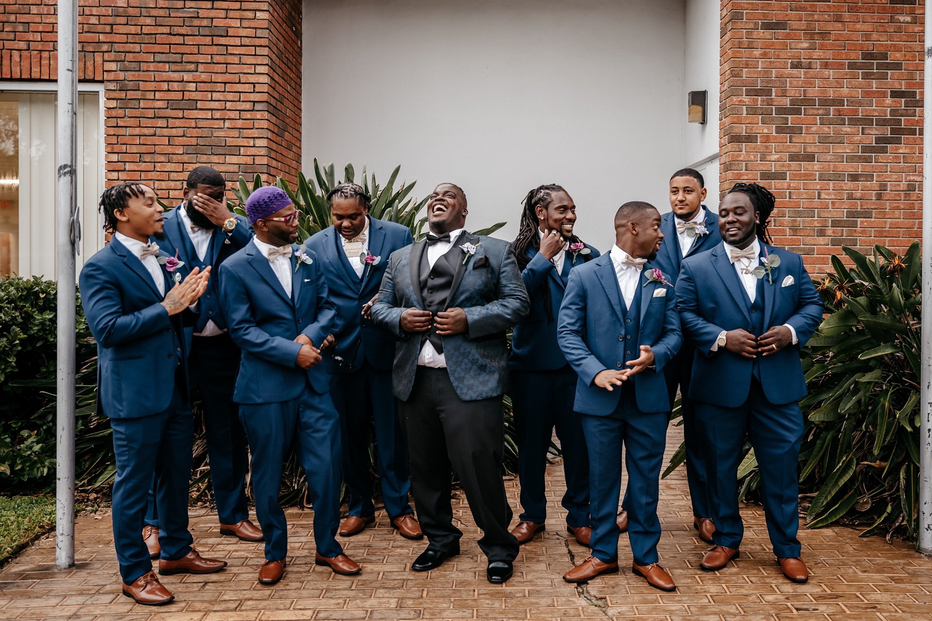 A groom and his groomsman laugh and celebrate as they prepare for the ceremony at a wedding in Florida