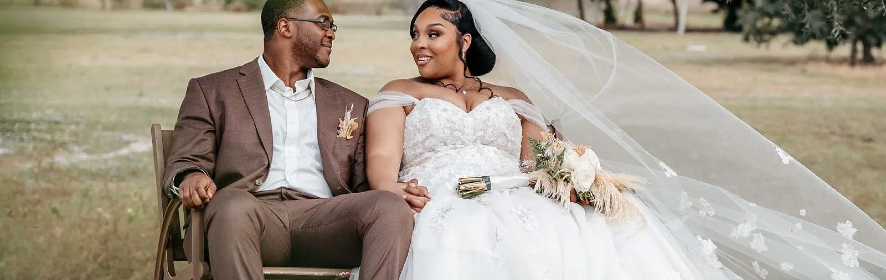 Bride and groom seated together outdoors during a romantic Florida wedding portrait.